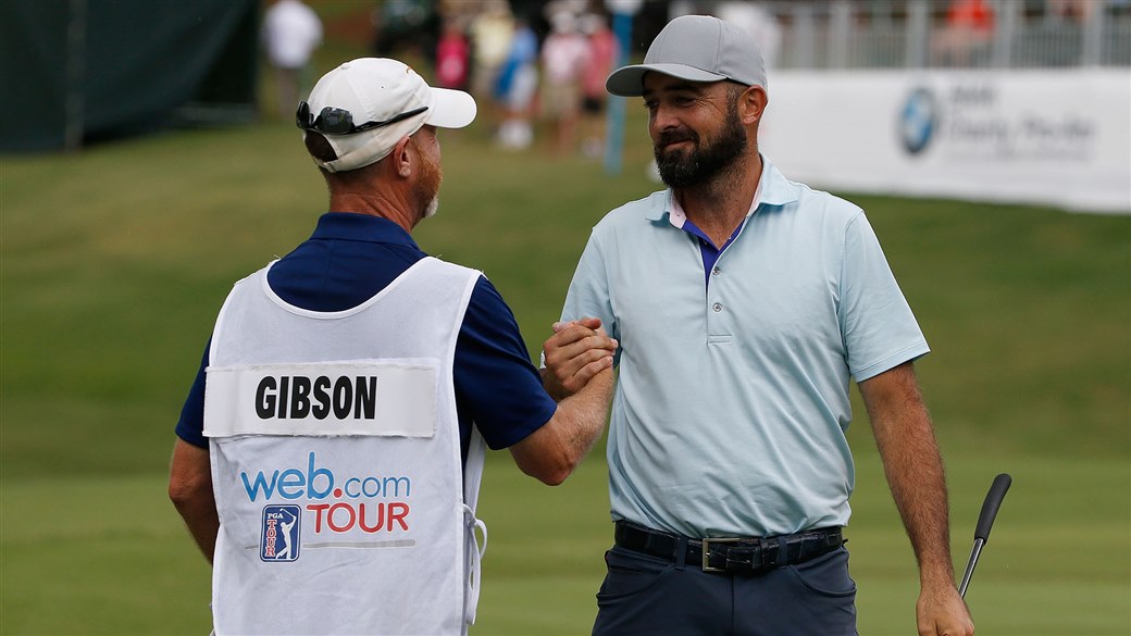 Rhein Gibson celebrates with his caddying after carding an 8-under-par 63 to close out the BMW Charity Pro-Am