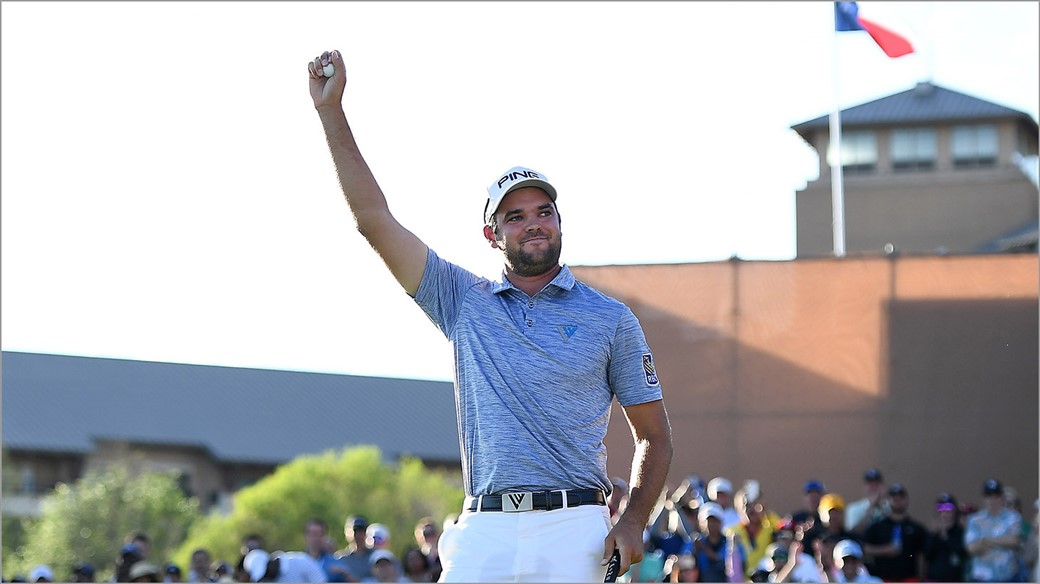 Corey Conners raises his Pro V1 golf ball In celebration after winning the 2019 Valero Texas Open