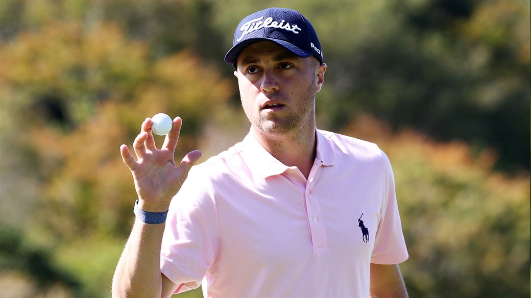 Justin Thomas salutes the crows after holing a putt during his win at the CJ Cup @ Nine Bridges