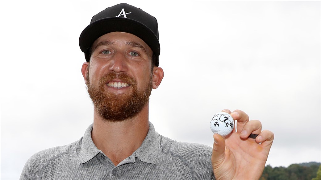 Kevin Chapell raises the Pro V1 golf ball he used to fired a 59 during second round action at the 2019 A Military Tribute at The Greenbrier, the 11th sub-60 in PGA Tour history.