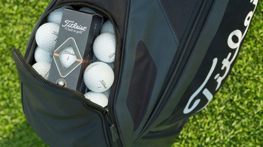 The ball pocket of a Titleist golf bag, filled with Pro V1 golf balls