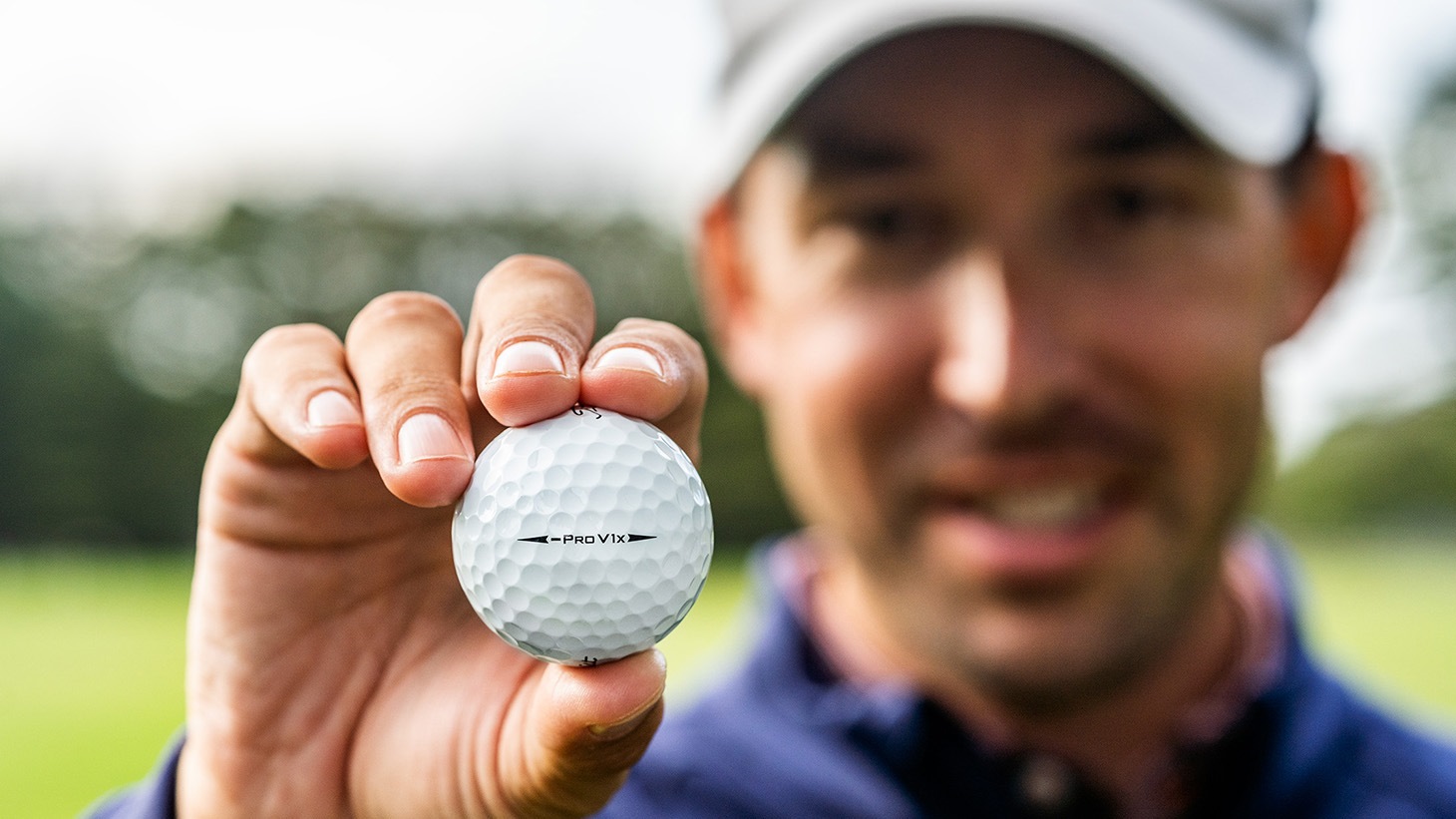 Golfer Raising a Pro V1x Left Dash Golf Ball